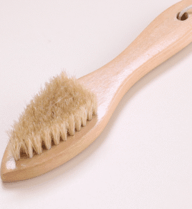 Wooden shoe brush with hanging loop and natural bristles, a shoe cleaning brush and brush for shoe maintenance.