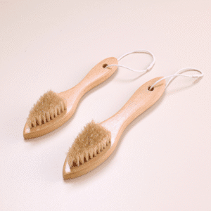 Wooden shoe brush with hanging loop and natural bristles, a shoe cleaning brush and brush for shoe maintenance.