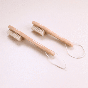 Wooden shoe brush with hanging loop and natural bristles, a shoe cleaning brush and brush for shoe maintenance.