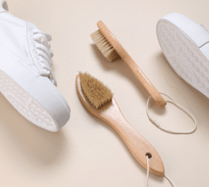 Wooden shoe brush with hanging loop and natural bristles, a shoe cleaning brush and brush for shoe maintenance.