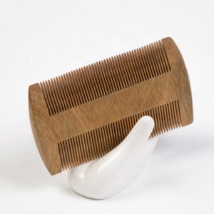 Wooden wide tooth comb with smooth sanded edges, dual-sided teeth for everyday detangling and grooming.