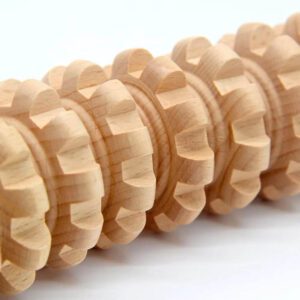 Wooden roller massager with multiple rotating discs, designed for massage therapy product use and muscle stimulation.