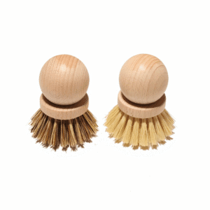 Two round beech wood dish brushes with natural bristles—one darker sisal blend and one light palm fiber—shown on a white background.