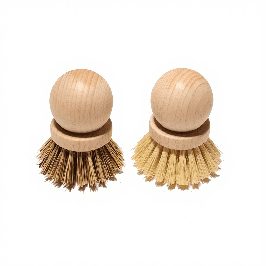 Two round beech wood dish brushes with natural bristles—one darker sisal blend and one light palm fiber—shown on a white background.