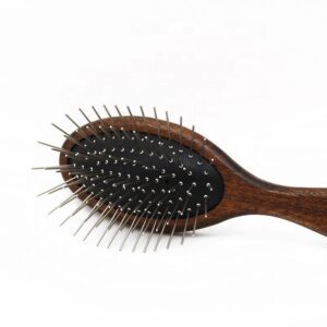 Wooden pet grooming brush with rounded stainless steel pins, designed for gentle cleaning and loose hair removal for dogs and cats