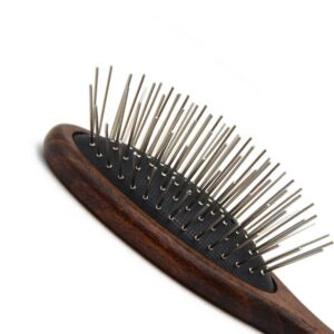 Wooden pet grooming brush with rounded stainless steel pins, designed for gentle cleaning and loose hair removal for dogs and cats