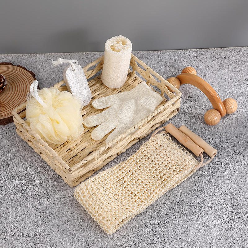 Shower gift set featuring body wash essentials like loofah, pumice stone, massager, gloves, and bath flower in a woven basket.