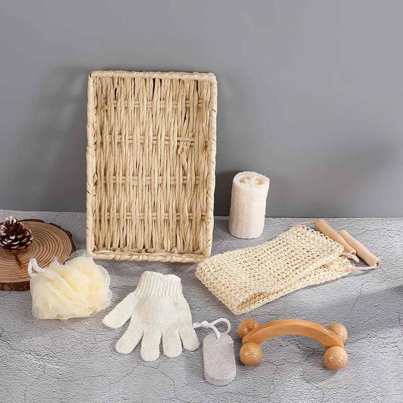 Shower gift set featuring body wash essentials like loofah, pumice stone, massager, gloves, and bath flower in a woven basket.