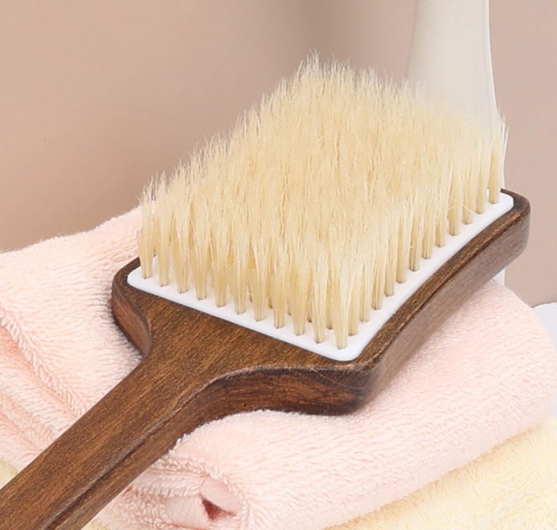 Bath brush with long handle made of dark wood and natural bristles, designed for dry body brushing and exfoliation.