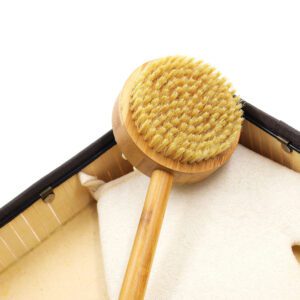 Boar bristle shower brush with a long wooden handle and dual-sided design for exfoliating and massaging during bath routines.