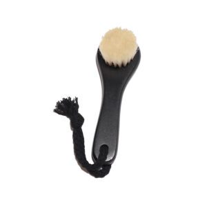Black body dry brush with soft goat hair bristles and compact handle, designed for gentle exfoliation.
