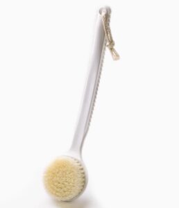Plastic body massage brush with soft bristles, perfect for gentle exfoliation and dry brushing for sensitive skin.
