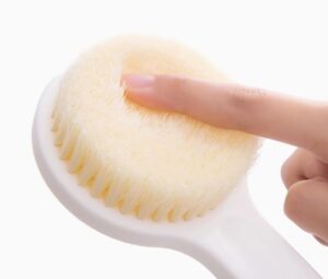 Plastic body massage brush with soft bristles, perfect for gentle exfoliation and dry brushing for sensitive skin.