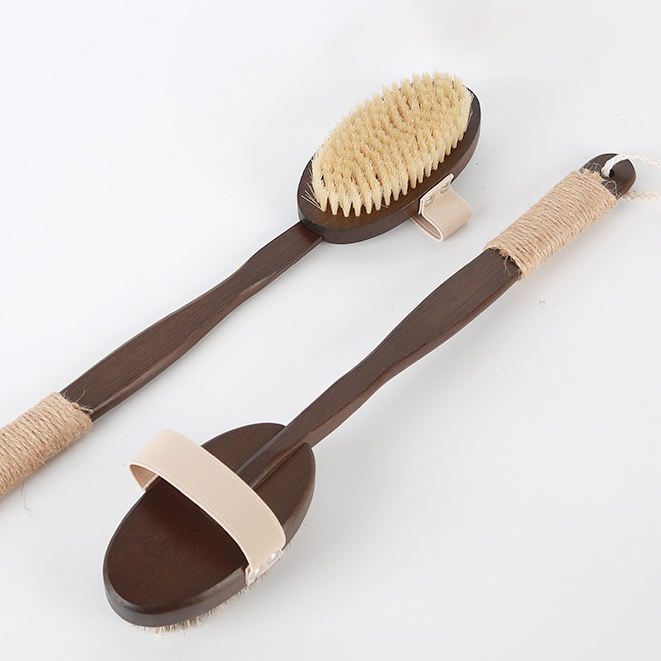 Natural bristle scrub brush with dark bamboo handle, featuring soft bristles and a strap for exfoliating and full-body cleansing.