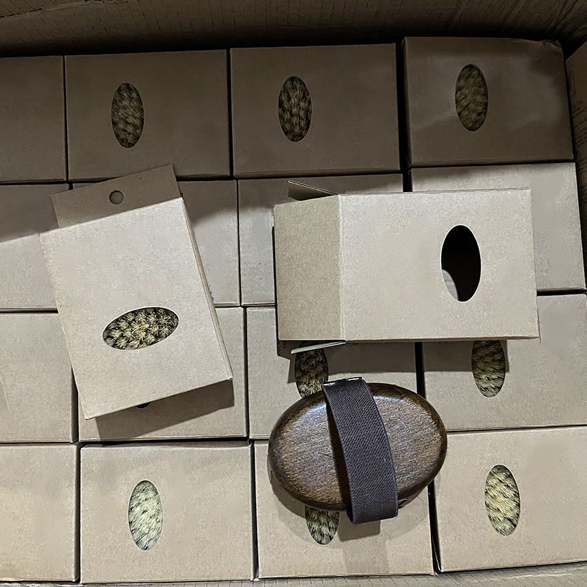 Wooden massage brush with boar bristle and hand strap, suitable for wet and dry use as a shower brush.