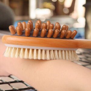 Natural bristle scrub brush with a long wooden handle and dual-side design, suitable for exfoliating as a natural scrub brush.