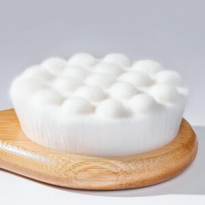 Shower back scrubber with a long wooden handle and soft cleansing pad, designed for bathing and body care.