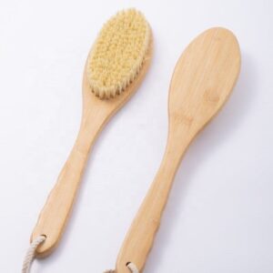 Skin care brush with bamboo handle and sisal bristles, designed for gentle exfoliation and healthy skin care routines.
