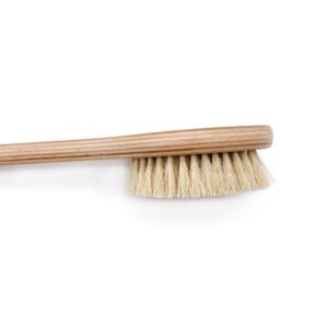 Natural bristle scrub brush with a long wooden handle, featuring soft boar bristles for gentle exfoliation during bathing.