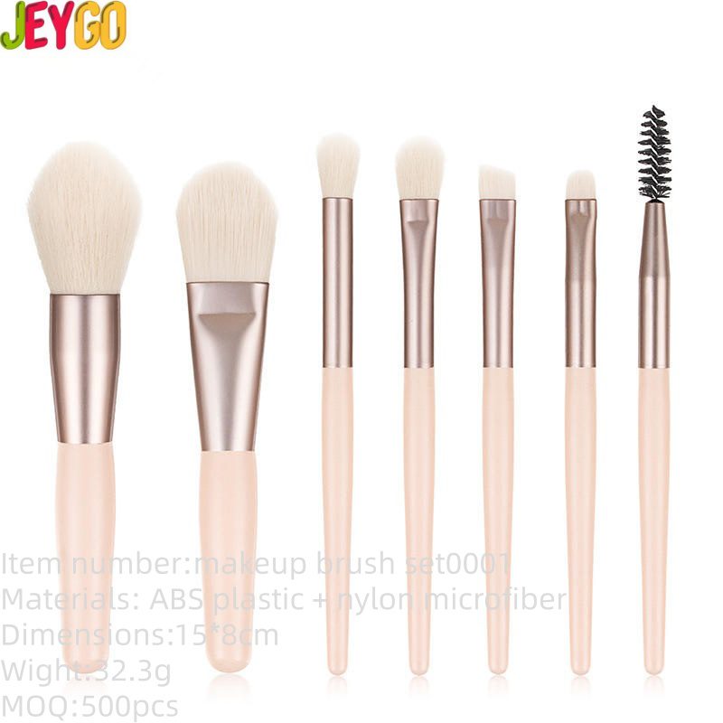 Pink makeup brush set featuring six professional cosmetic brushes for foundation, concealer, blush, eyeshadow, eyeliner, powder application, and eyebrow grooming with soft synthetic bristles.