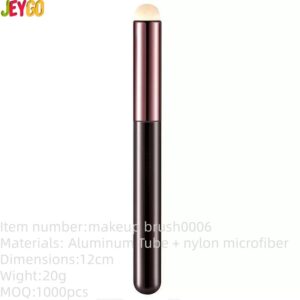 Compact multifunctional flat makeup brush with synthetic bristles and metallic handle, suitable for lipstick, lip gloss, concealer, and detailed facial makeup application.