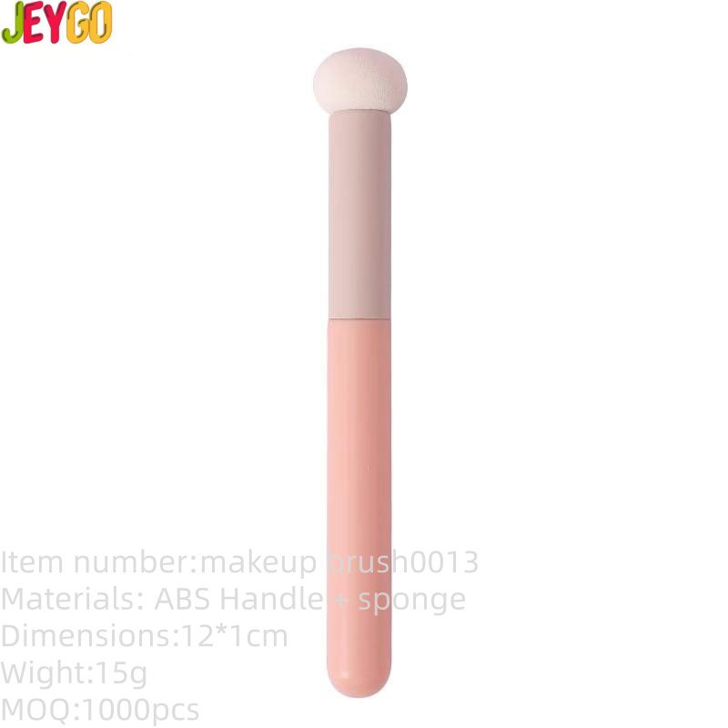 Portable concealer brush with soft mushroom sponge applicator and pink ABS handle, designed for blending concealer, lipstick, foundation, and cream cosmetics.
