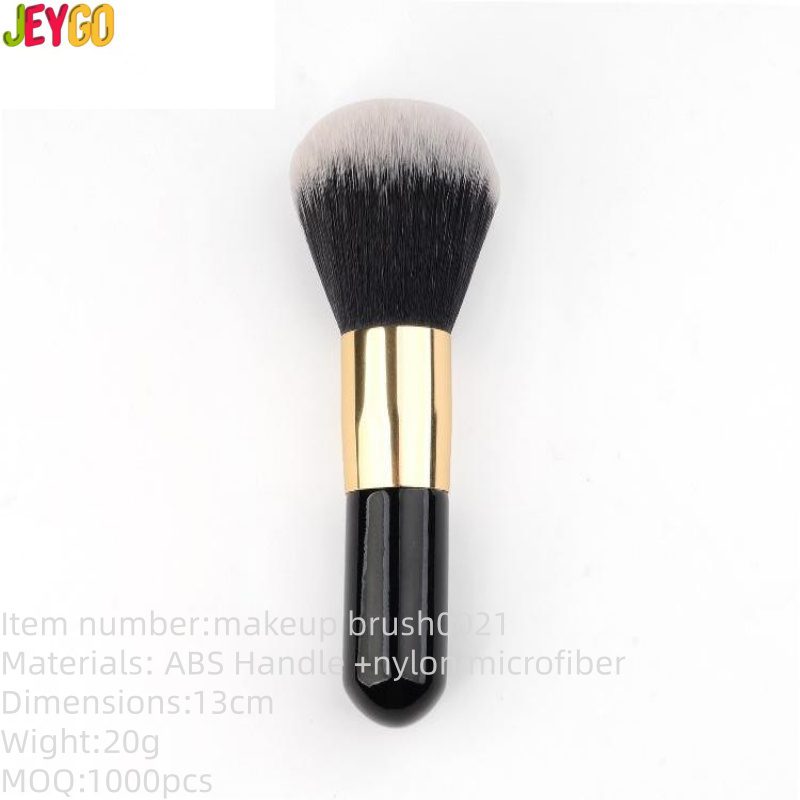 Professional vegan foundation makeup brush with dense black and white synthetic bristles, gold ferrule, and black handle for foundation, concealer, powder, and cosmetic blending.