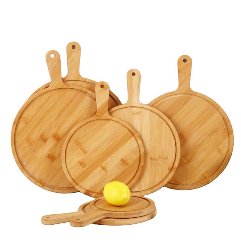 round bamboo pizza board with paddle handle and juice groove for serving pizza, cheese, bread and appetizers