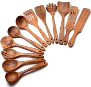Twelve-piece set of natural teak wooden kitchen utensils including spatulas, slotted spoons, soup spoons, serving utensils, and stirring tools, designed for cooking and serving