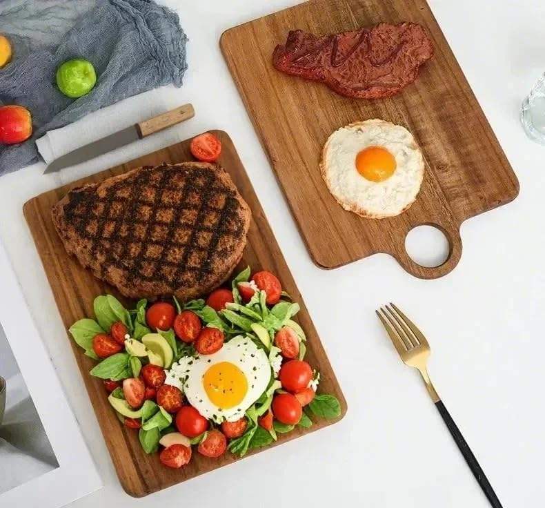 rectangular acacia wood cutting board with integrated hanging handle for chopping, serving, and food presentation