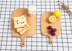 Two solid beech wood cutting boards with handles, ideal for slicing fruit, bread, and pizza, suitable for home baking, kitchen prep, and serving