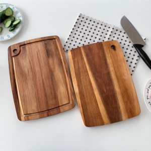 Rectangular acacia wood cutting board with built-in juice groove and hanging hole, ideal for chopping fruits, vegetables, and meats, suitable for kitchen use and serving