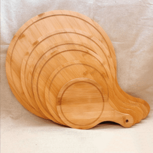 round bamboo pizza board with paddle handle and juice groove for serving pizza, cheese, bread and appetizers