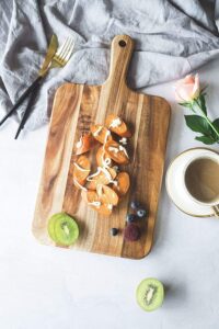 acacia wood cutting board with handle for pizza serving, cheese presentation, bread display and food preparation