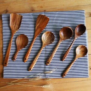 Set of five natural acacia wood kitchen utensils including spatulas, slotted spoons, and stirring tools, designed for non-stick cookware and home cooking