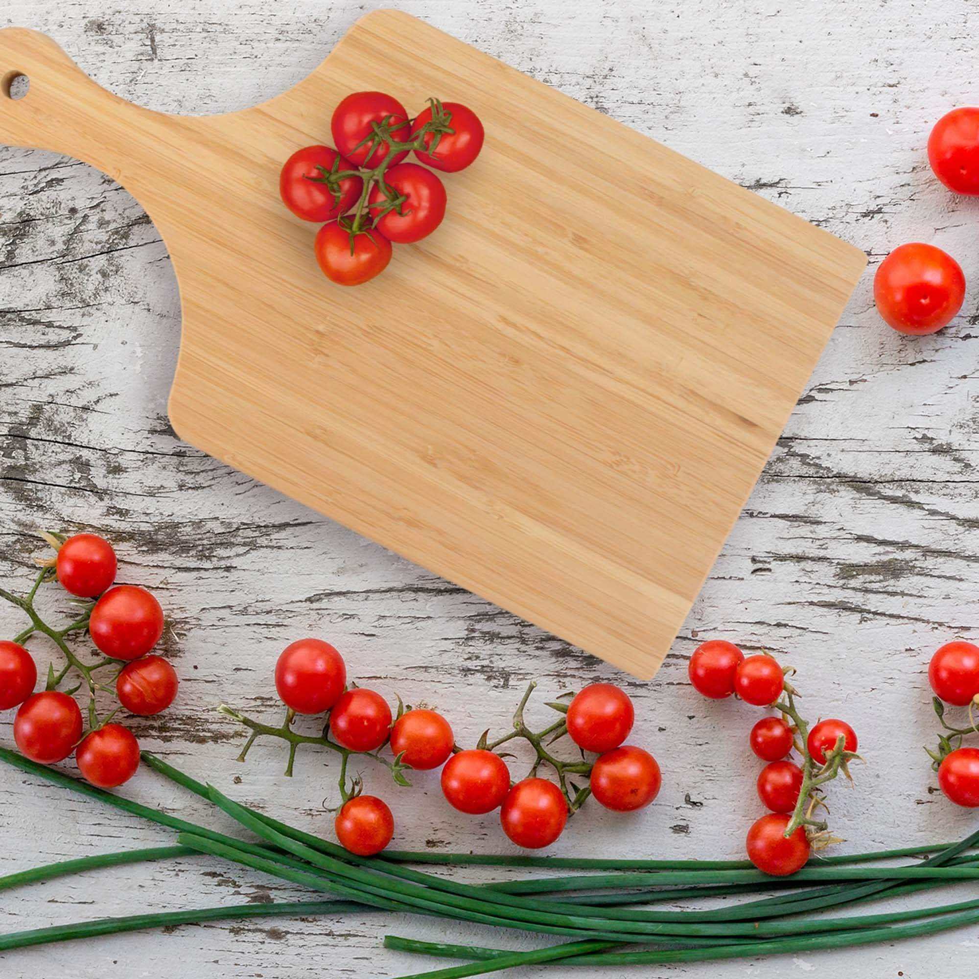 double-sided bamboo cutting board with paddle handle and hanging hole for chopping, slicing, and serving food