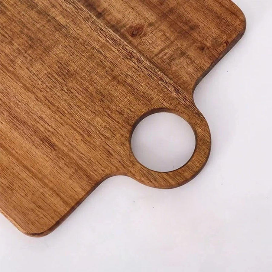 rectangular acacia wood cutting board with integrated hanging handle for chopping, serving, and food presentation