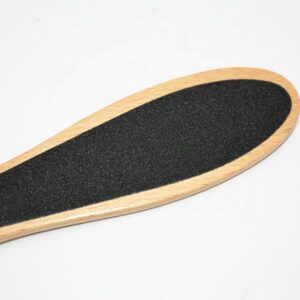Double-faced wooden pedicure foot scrub with sandpaper surface for callus removal and smooth feet care.