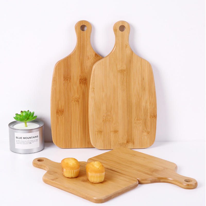 large bamboo cutting board with rounded handle and hanging hole for food preparation and serving