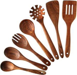Seven-piece acacia wood cooking utensil set including spatulas, serving spoons, pasta server, slotted spoon, and cooking tools designed for non-stick cookware and kitchen use