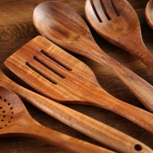 Seven-piece acacia wood cooking utensil set including spatulas, serving spoons, pasta server, slotted spoon, and cooking tools designed for non-stick cookware and kitchen use