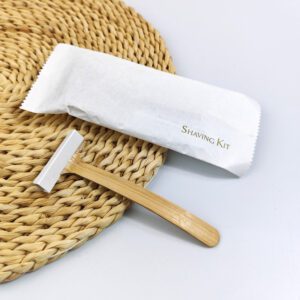 Bamboo system razor with dual stainless steel blades and natural wooden handle, designed for hotel amenities and sustainable shaving.