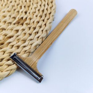 Bamboo system razor with dual stainless steel blades and natural wooden handle, designed for hotel amenities and sustainable shaving.