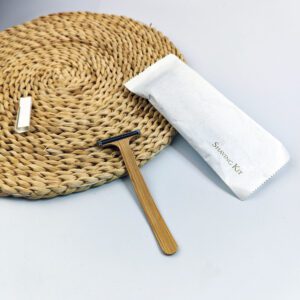 Bamboo system razor with dual stainless steel blades and natural wooden handle, designed for hotel amenities and sustainable shaving.