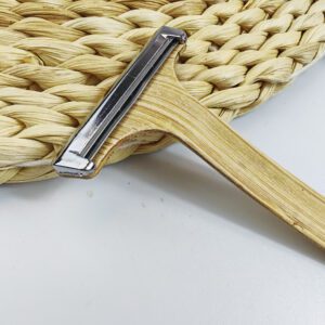 Bamboo system razor with dual stainless steel blades and natural wooden handle, designed for hotel amenities and sustainable shaving.