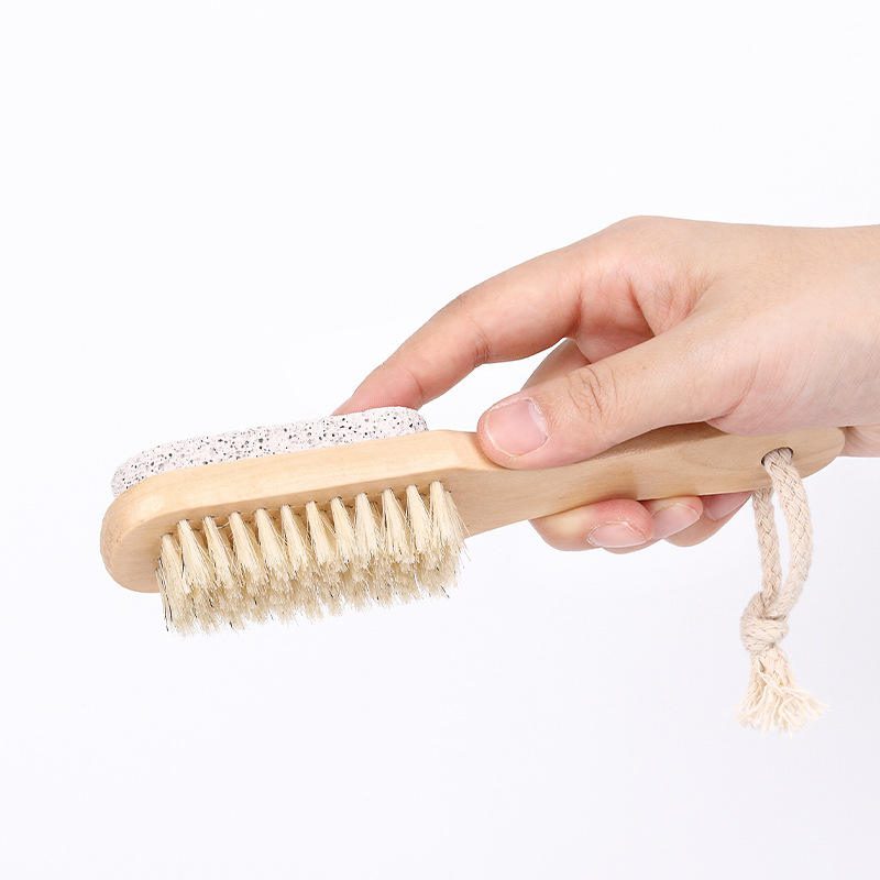 Wooden foot scrubber featuring natural boar bristles and pumice stone for exfoliating dead skin, cleaning feet, and removing calluses