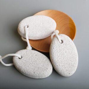 Colored natural lava pumice stone foot exfoliator with hanging rope, designed to remove dead skin, smooth rough heels, and support regular pedicure care.