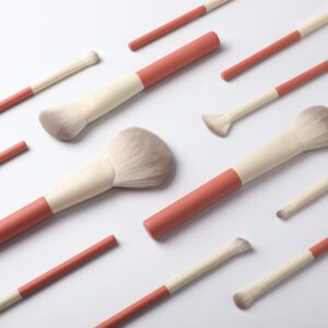 12-piece professional makeup brush set with pink and white handles, featuring synthetic hair brushes for face makeup, concealer, eyeshadow, mascara, blending, and fan brush application.