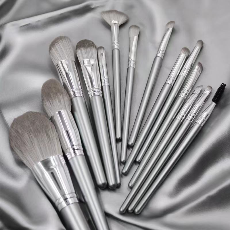 14-piece synthetic hair makeup brush set with champagne silver handles, including face brushes, eye shadow brushes, powder brushes, blush brushes, concealer brushes, and a portable brush case.