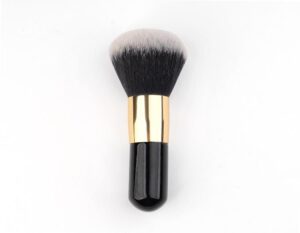 Professional vegan foundation makeup brush with dense black and white synthetic bristles, gold ferrule, and black handle for foundation, concealer, powder, and cosmetic blending.